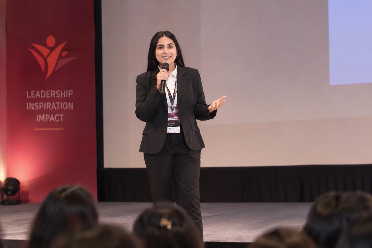 Sachi Tamrakar speaking on stage at a leadership event