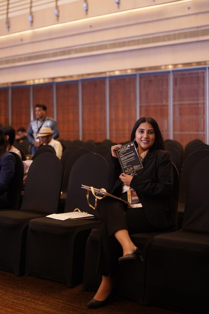 Sachi Tamrakar holding a certificate at an event