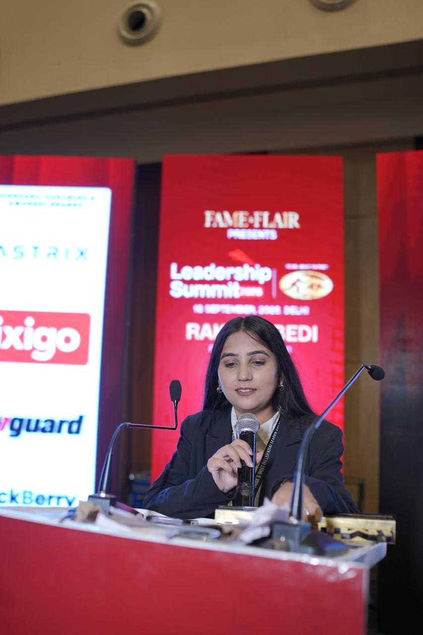 Sachi Tamrakar speaking at the podium at a leadership summit